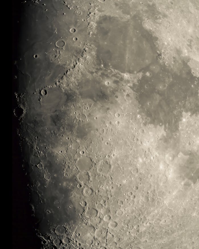 why-choose-us Detailed lunar surface photo highlighting craters and texture under sunlight.