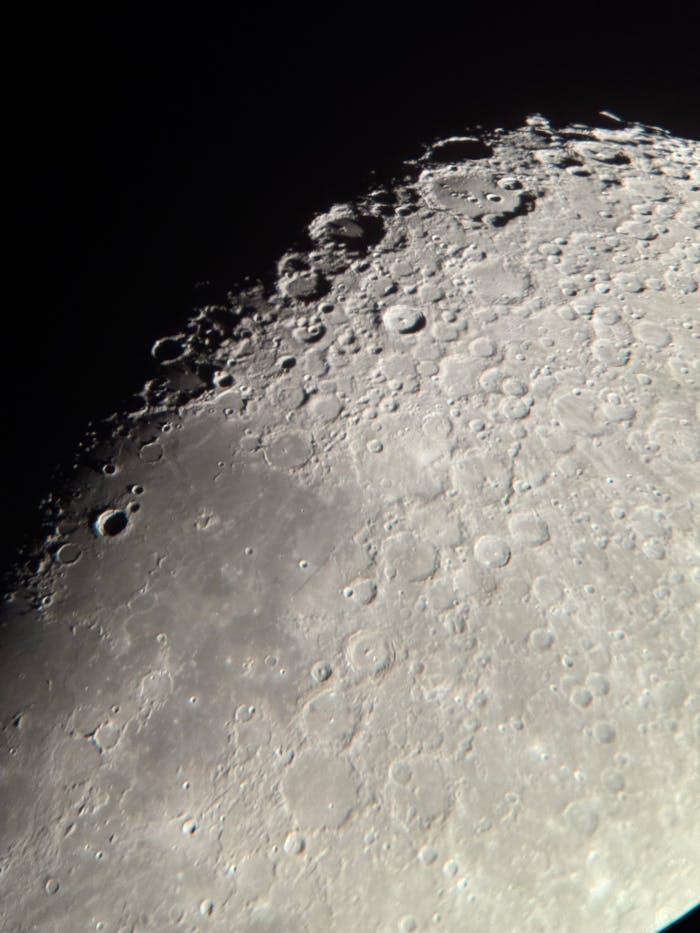 Close-up of moon's surface showcasing craters and texture in natural satellite.