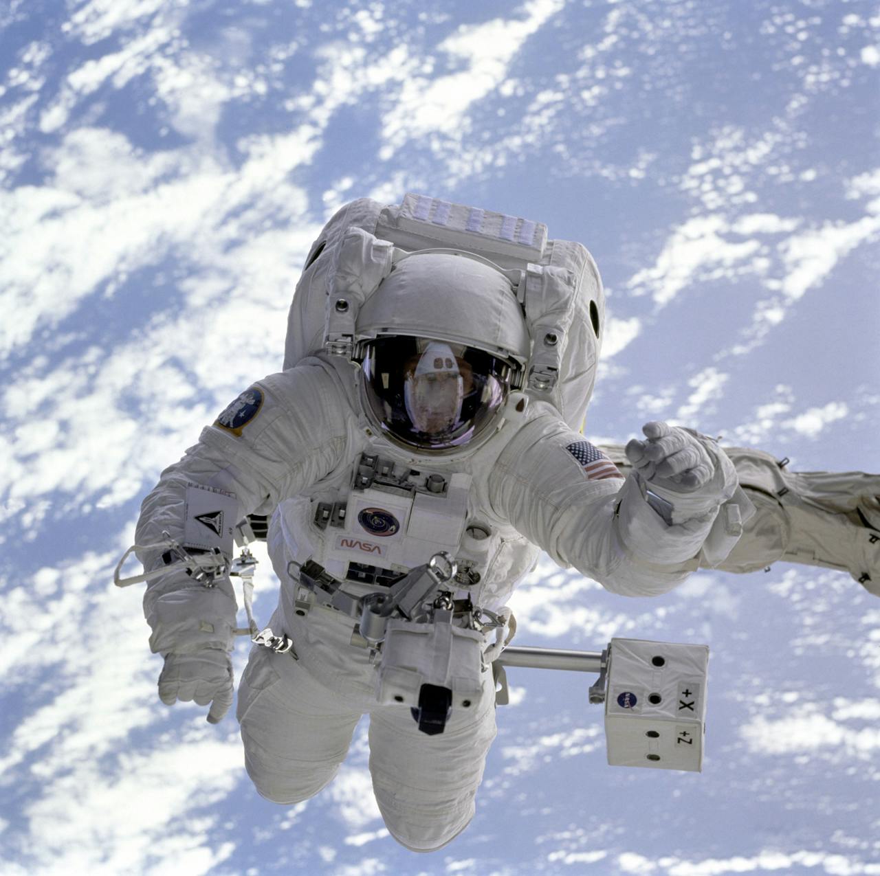home-hero Astronaut conducting a spacewalk with Earth in the background, showcasing outer space exploration.